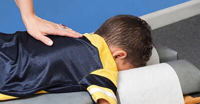 child receives chiropractic treatment at Pine Cone Health centre