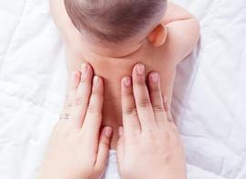 Infant get massage therapy on her back