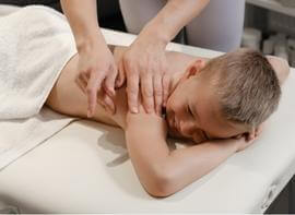 child gets a massage at Pine Cone